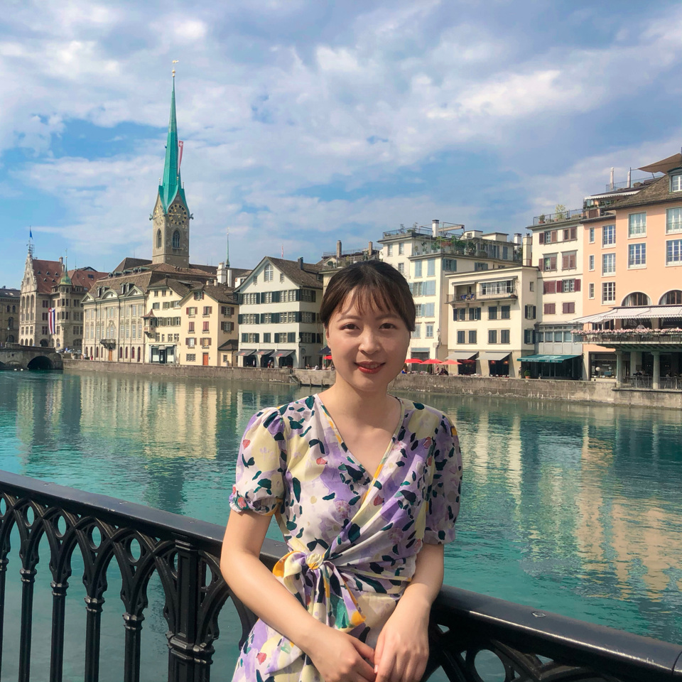 Ting beside the Limmat in Zurich, with the old town behind her